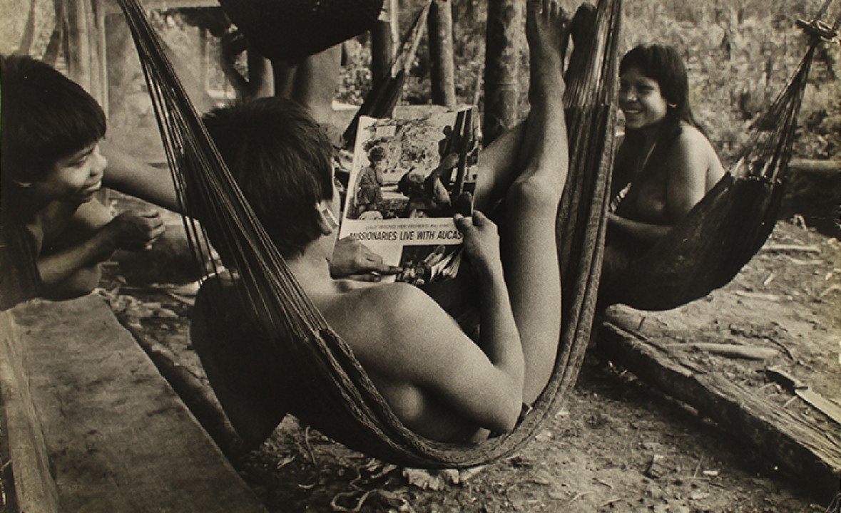 Photograph of Waodäni People Looking at a Publication Titled, “Missionaries Live with Aucas”
